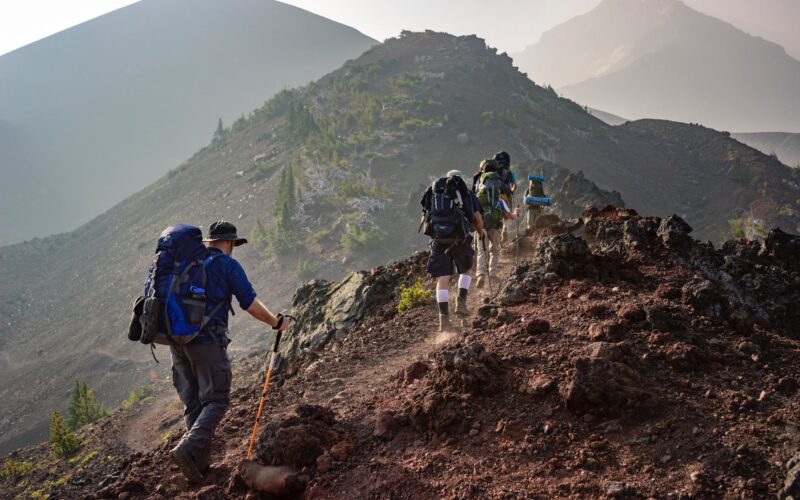 group of person walking in mountain